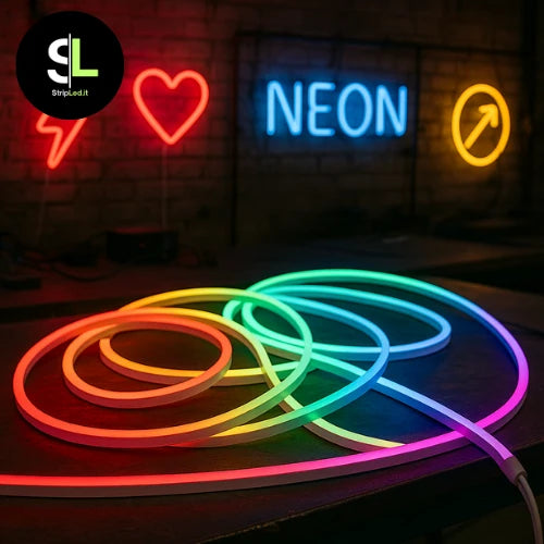 Striscia LED neon RGB accesa su banco da lavoro con insegne luminose sullo sfondo e logo Stripled.it