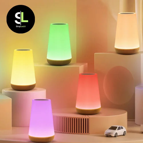 Luci notturne RGB dimmerabili accese in diversi colori su base legno moderna con logo StripLed.it