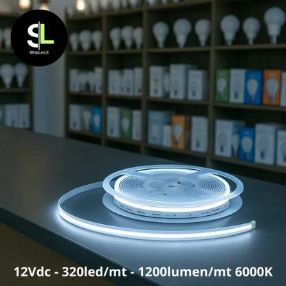 Striscia LED COB 12V 320led/m bianco freddo 6000K accesa su banco di negozio e logo StripLed.it