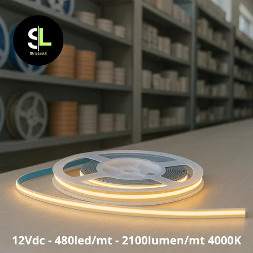 Striscia LED COB 12V bianco naturale 4000K accesa su banco da lavoro e logo StripLed.it