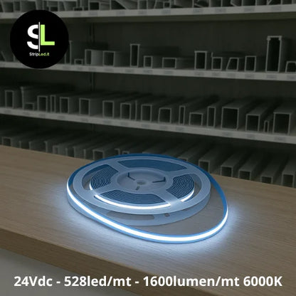 Striscia LED COB 24V bianco freddo 6000K accesa su banco di magazzino con logo StripLed.it